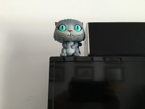 Cheshire Cat sitting on the TV